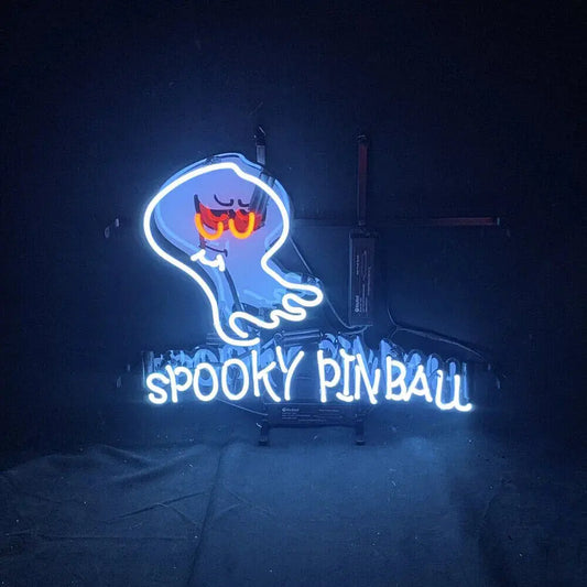 Neon sign of a ghost with glowing text 'Spooky Pinball' on a dark background