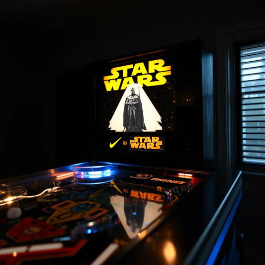 Illuminated Star Wars themed pinball topper mounted above the playfield with soft LED glow.