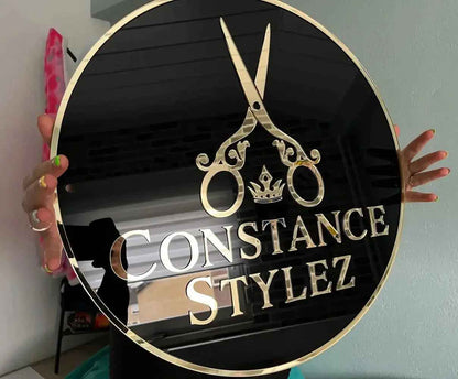 Custom round black sign with gold scissors, crown, and 'Constance Stylez' text for salon branding