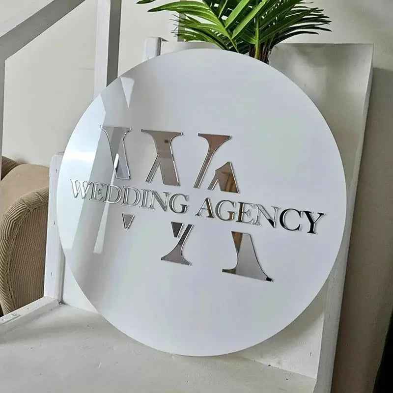 Custom circular white sign with cutout 'WEDDING AGENCY' text and geometric shapes, modern interior decor