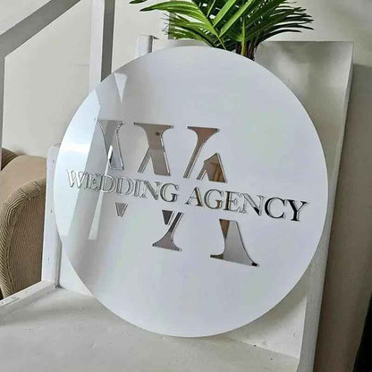 Custom circular white sign with cutout 'WEDDING AGENCY' text and geometric shapes, modern interior decor