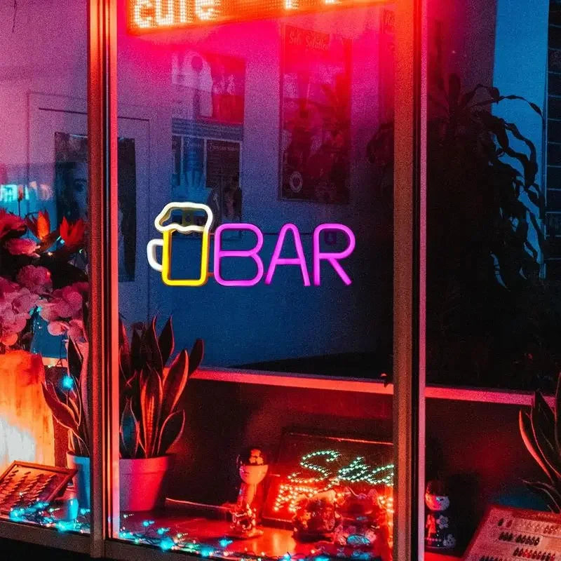 Vibrant neon bar sign with beer mug icon, glowing in pink and purple hues, perfect for arcade or game room decor.