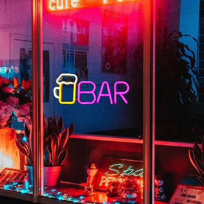 Vibrant neon bar sign with beer mug icon, glowing in pink and purple hues, perfect for arcade or game room decor.