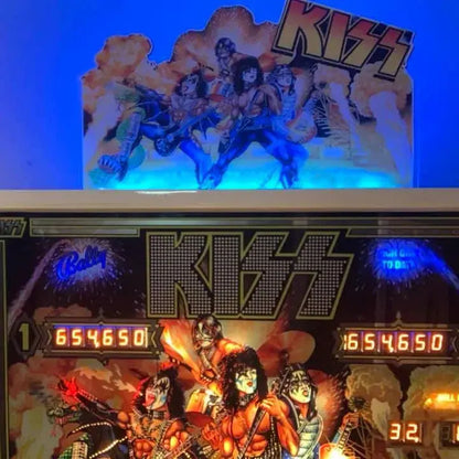 Woman in front of a KISS-themed pinball machine with colorful graphics and 'Kiss' branding.