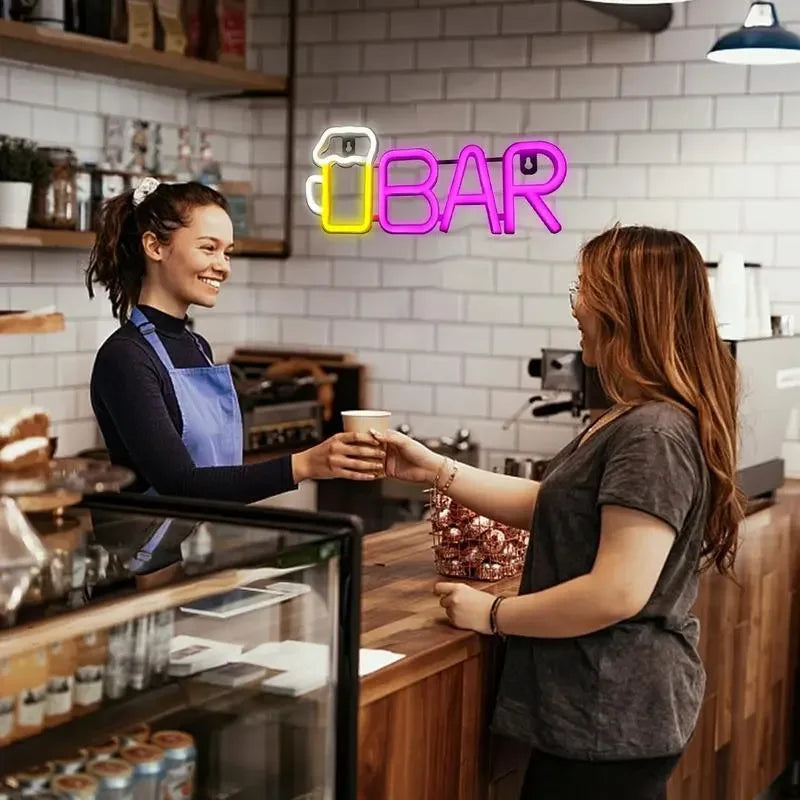 Neon bar sign with beer mug icon glowing above café counter, serving coffee to customer