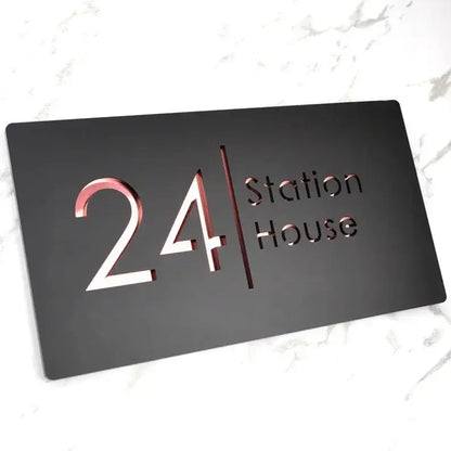 Modern black address plaque with rose gold '24 Station House' text, sleek design for home or business