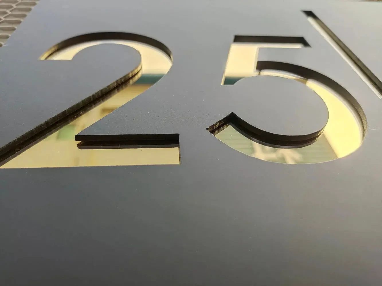 Custom cut number 25 in black with gold backing, ideal for arcade or pinball toppers