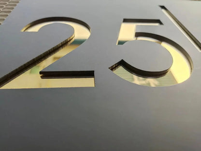 Custom cut number 25 in black with gold backing, ideal for arcade or pinball toppers