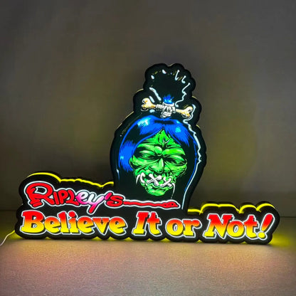 Neon sign with Ripley's Believe It or Not logo on a dark background