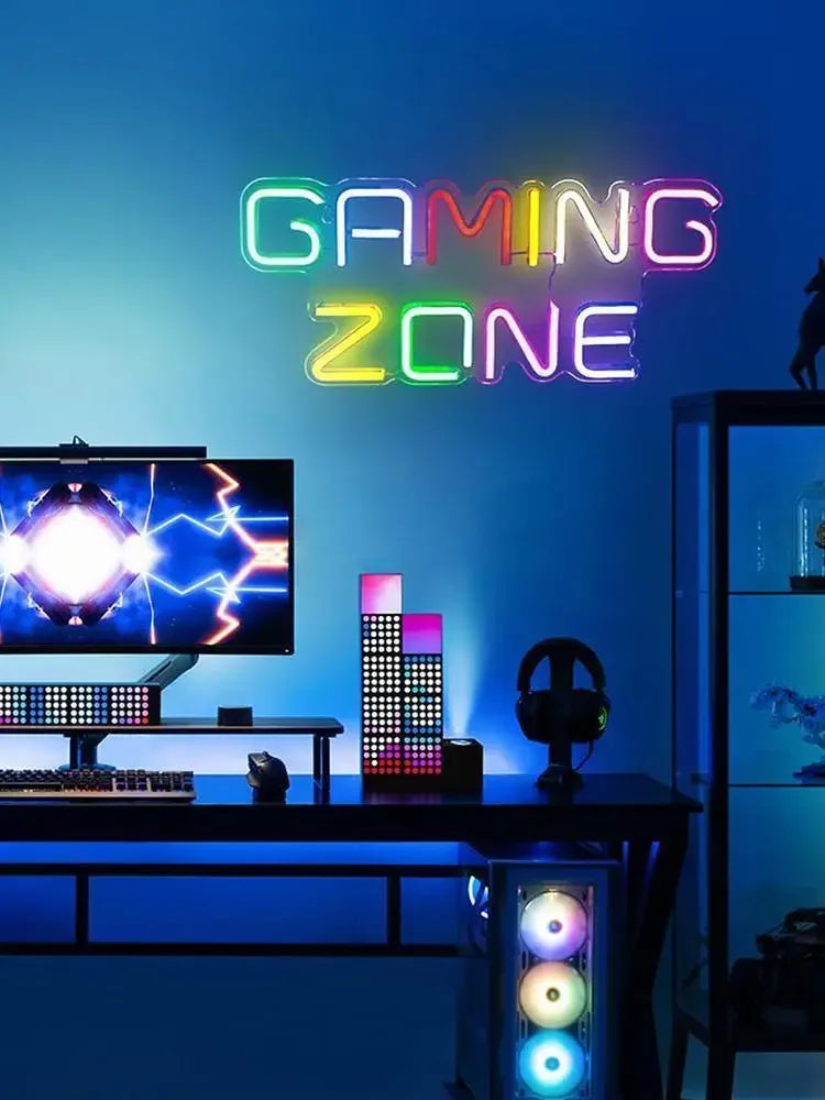 Colorful neon 'GAMING ZONE' sign above gaming desk with RGB PC and monitor, perfect for arcade toppers or custom game room decor