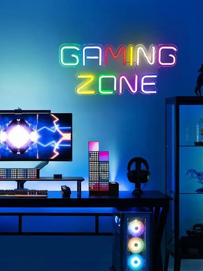 Colorful neon 'GAMING ZONE' sign above gaming desk with RGB PC and monitor, perfect for arcade toppers or custom game room decor